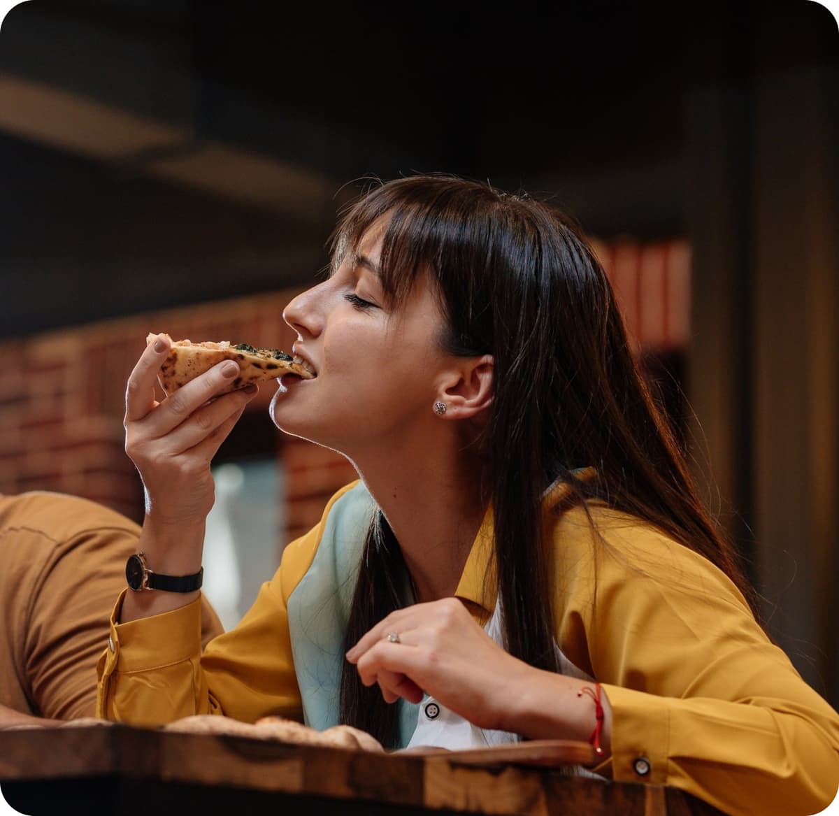 A girl enjoying a meal in a restaurant